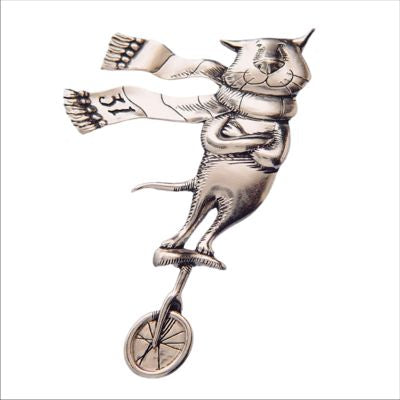 Edward Gorey Cat on a Unicycle Sterling Silver Pin.  This silver animal pin of an improbable Cat on a Unicycle has been adapted from a drawing in the book Category, also known as Cat E Gorey